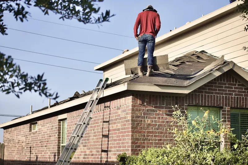 Professional roofer working on a residential roof in North Bend Heights